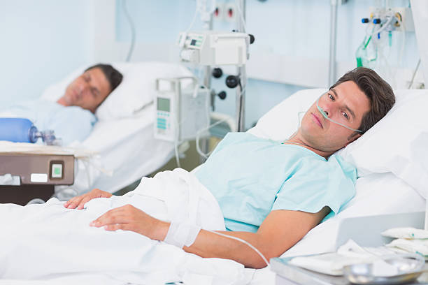 man lying in hospital bed