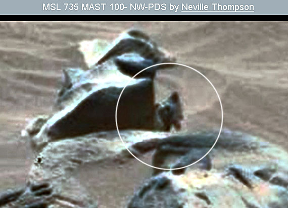 Mars-humanoid-standing-near-rock-holding-something