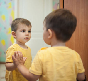 child-looking-into-mirror